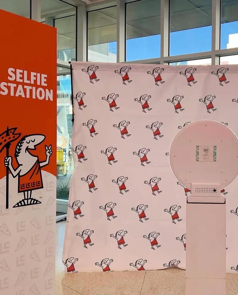 Corporate selfie station photo booth setup with branded backdrop