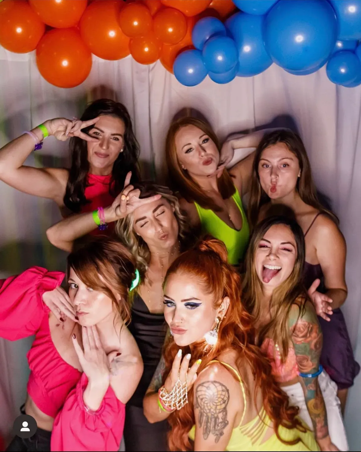 Birthday party guests in photo booth with custom backdrop
